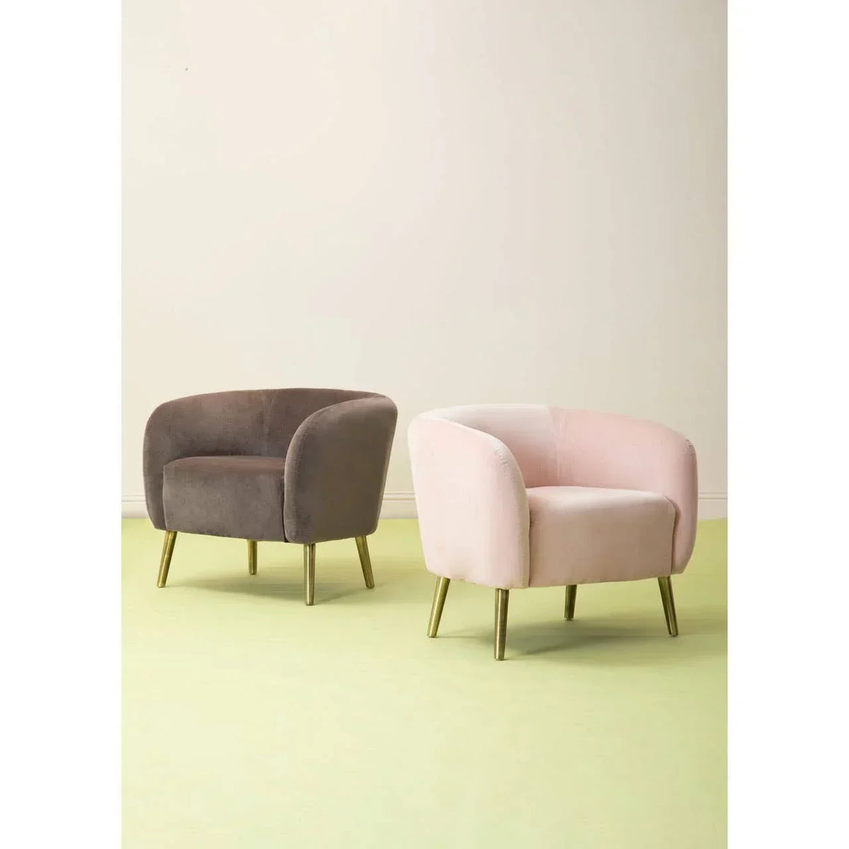 Velvet accent armchairs in blush pink and taupe with gold legs on pale flooring