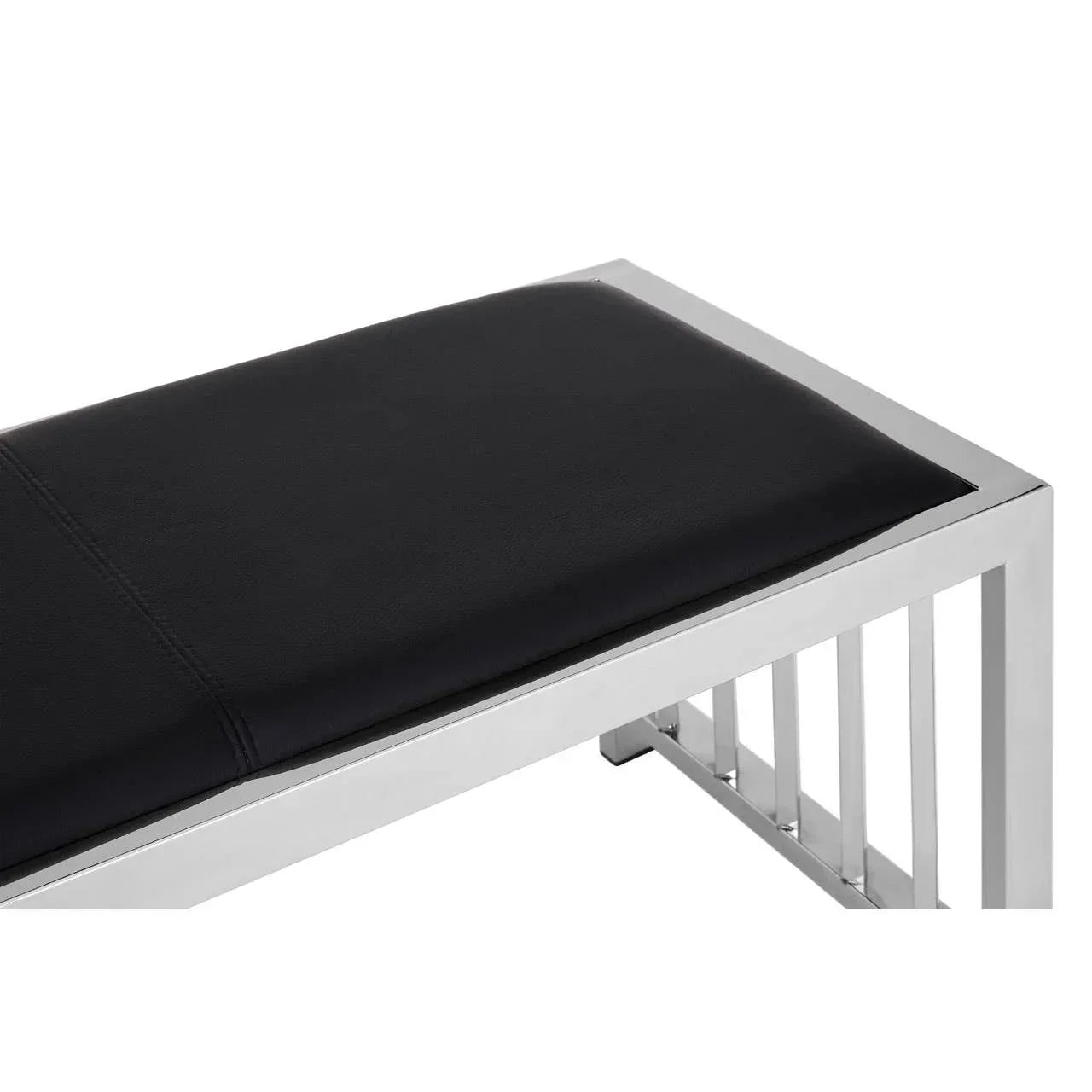 Modern bench with black padded seat and chrome metal frame, close-up corner view