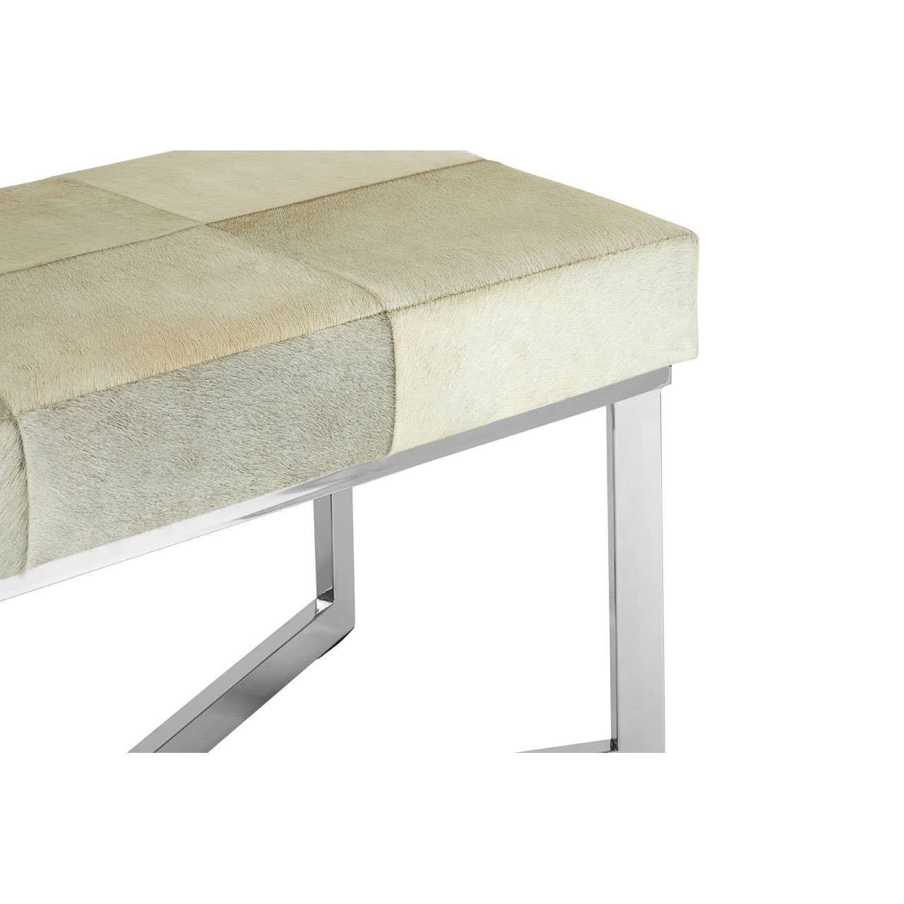 Beige upholstered bench with chrome metal legs, closeup of seat and frame