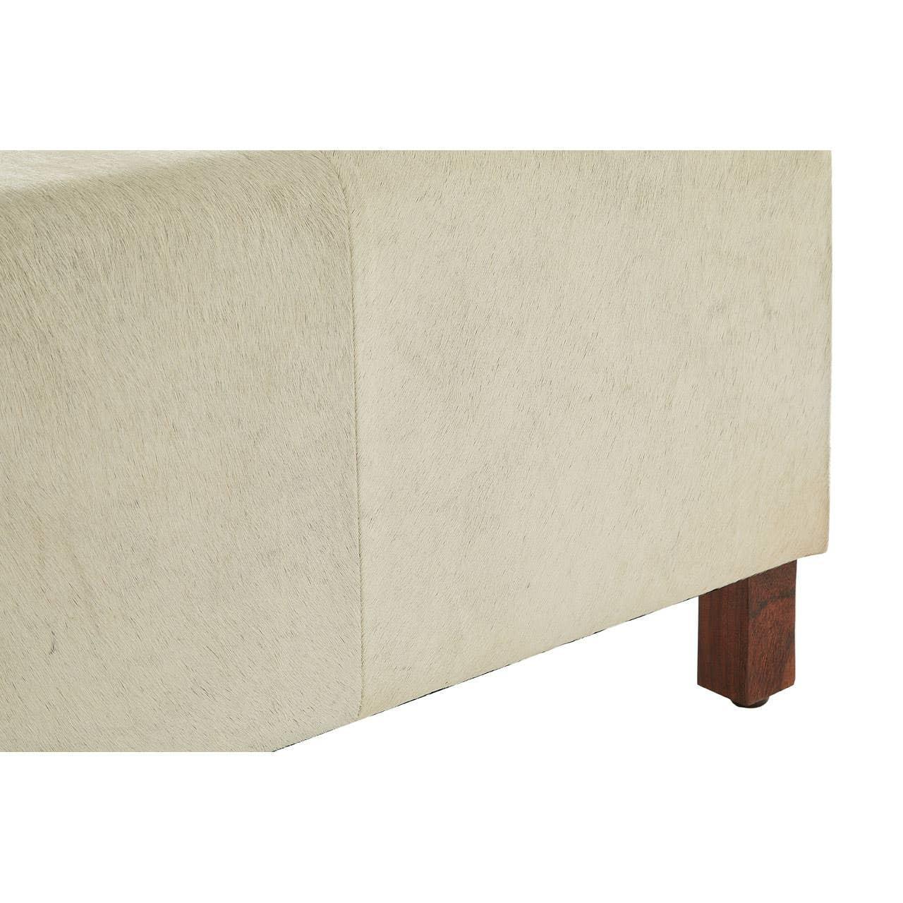Cream upholstered bench corner with wooden leg and soft textured fabric finish