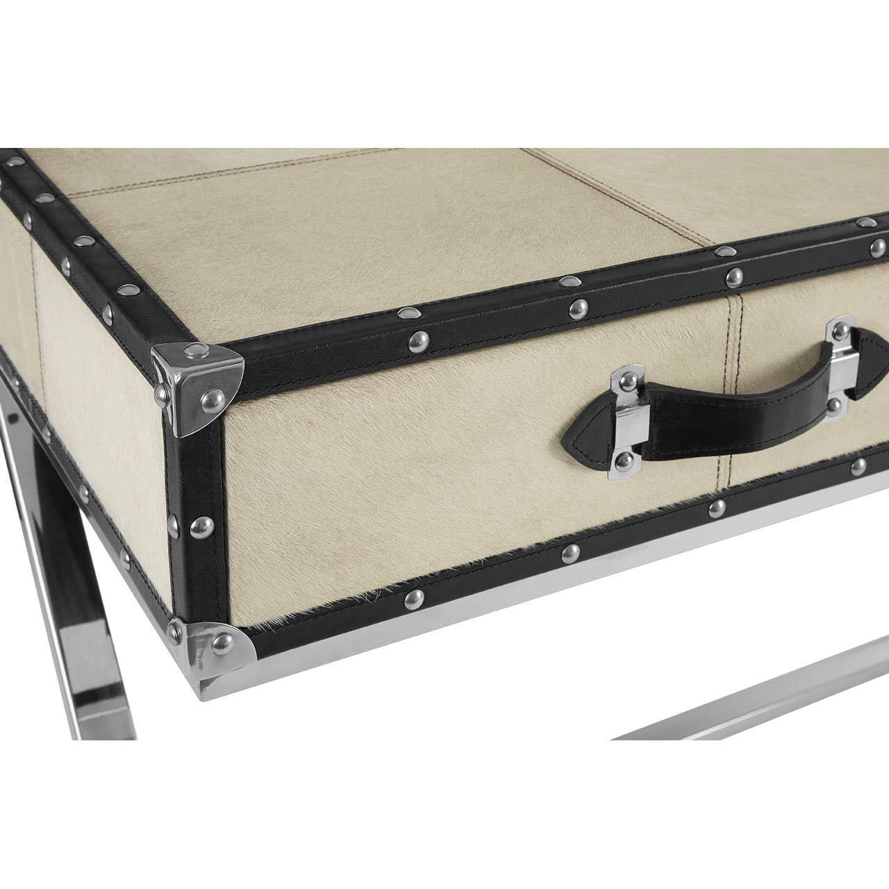 Close-up of cream and black studded desk with metal legs and handle