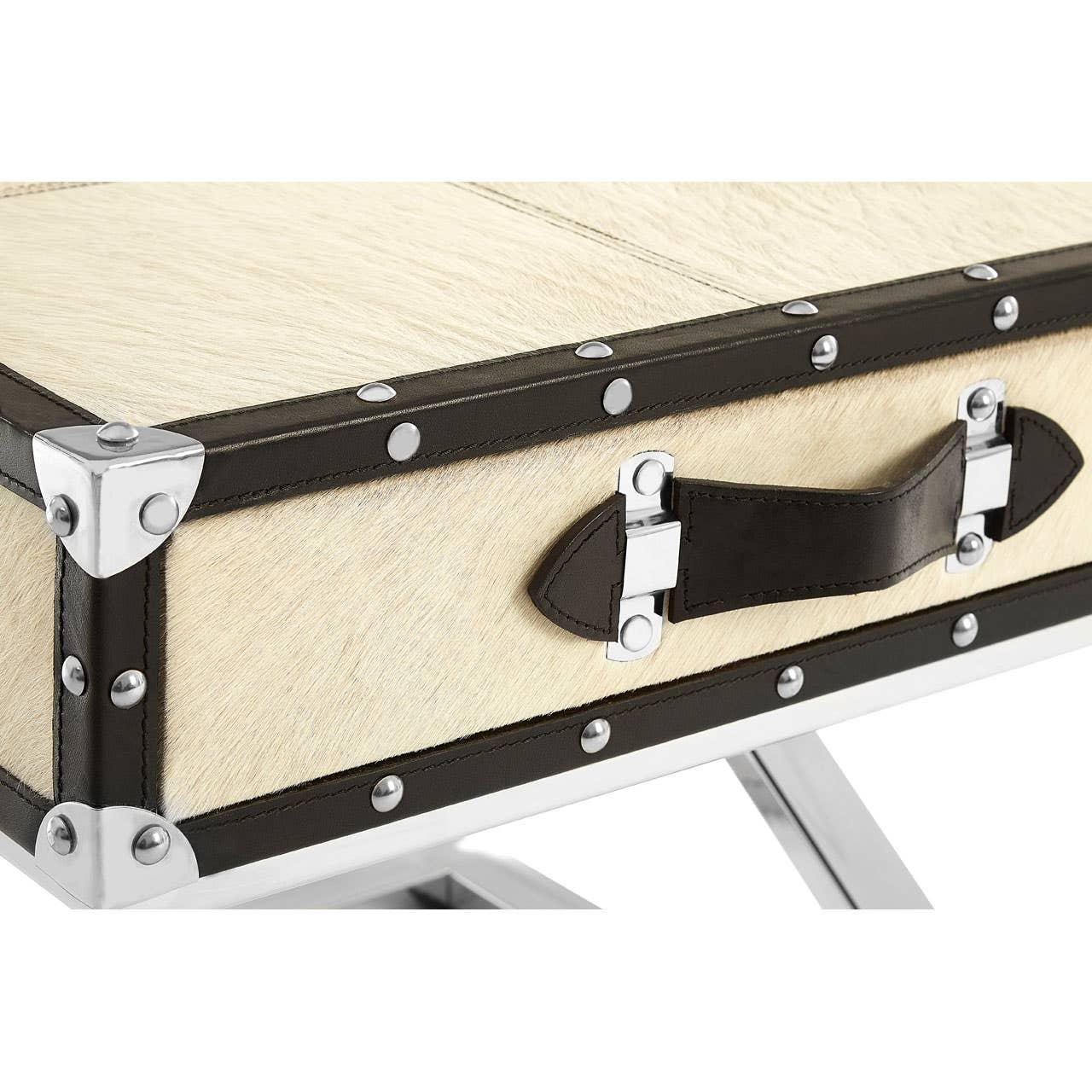 Cream and brown trunk coffee table with metal accents and leather handle close-up