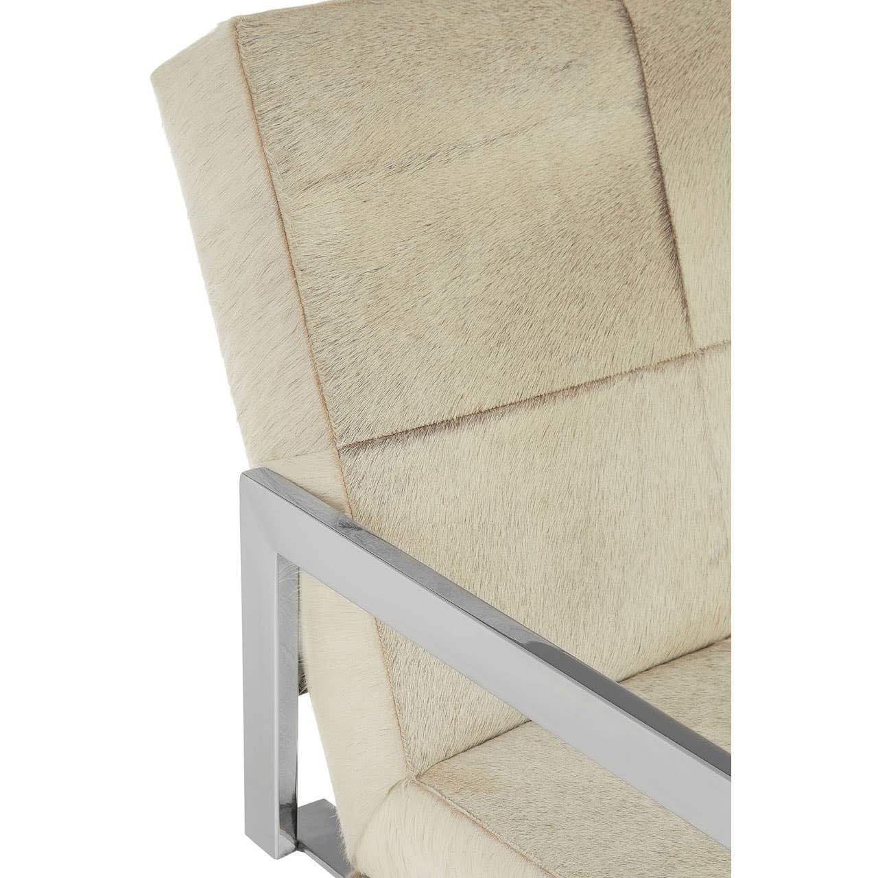 Beige faux fur armchair with brushed metal frame, close-up of seat and backrest