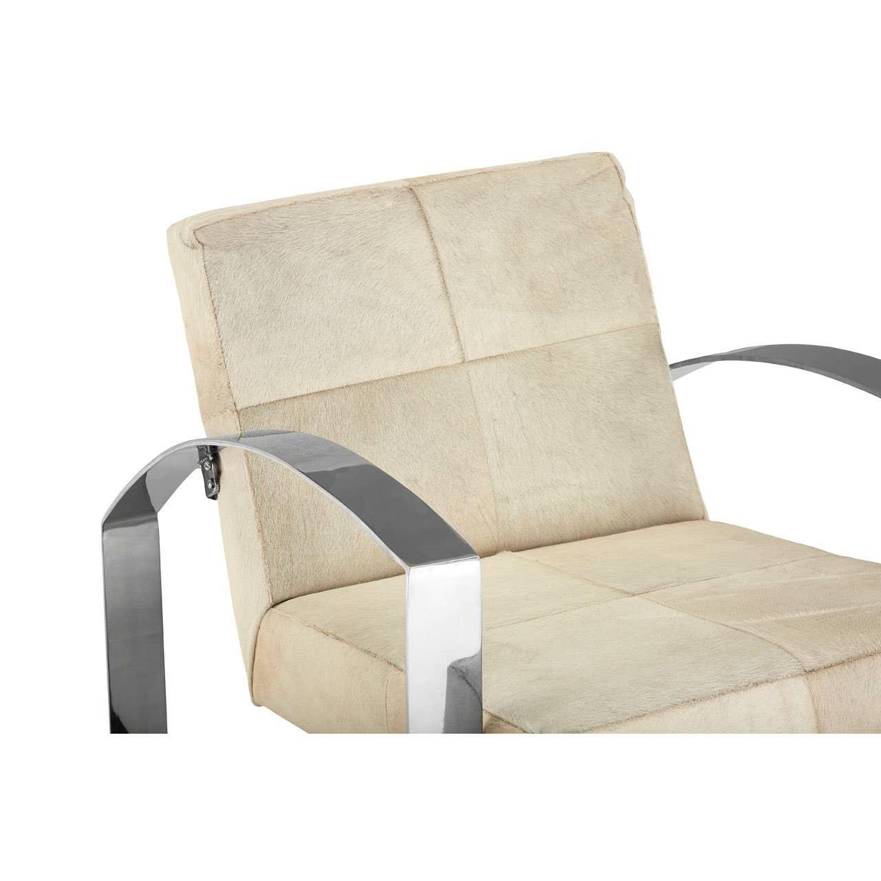 Beige upholstered accent chair with chrome metal arms, close-up of seat and backrest