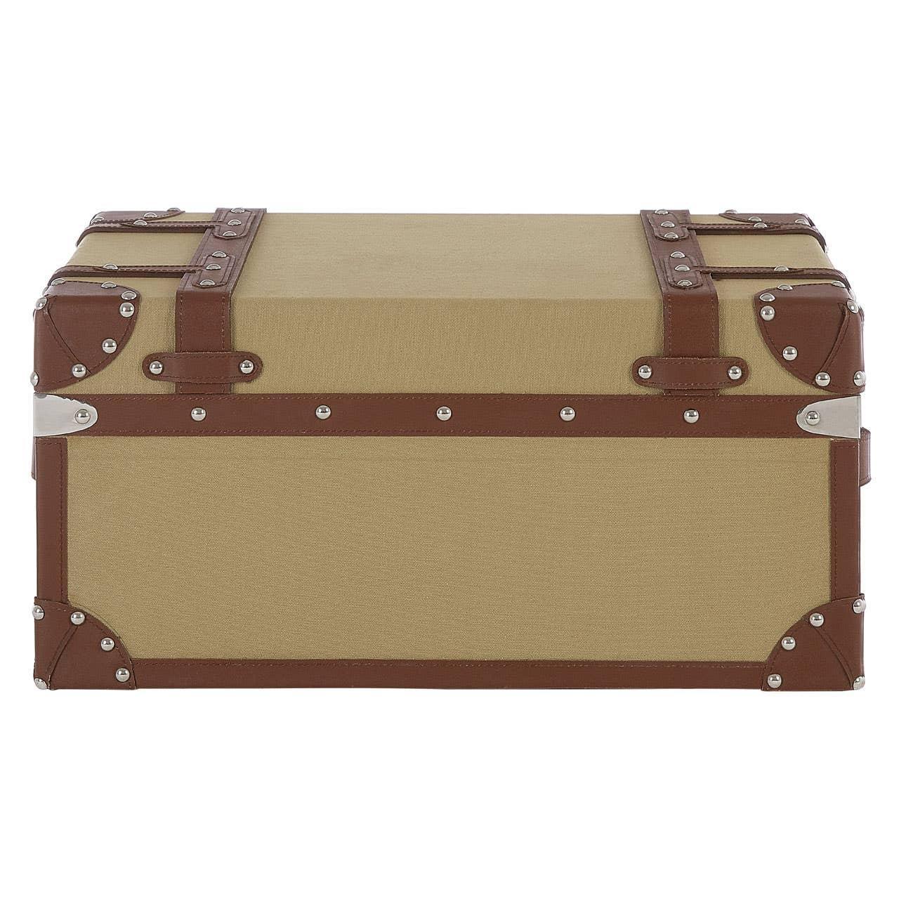 Beige storage trunk with brown faux leather trim and metal corner details, front view