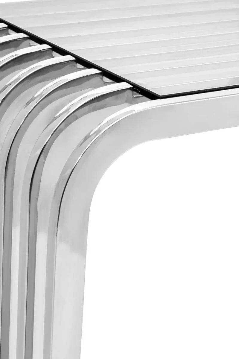 Close-up of modern chrome dining table legs and slatted tabletop