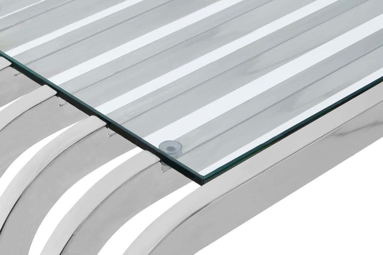 Closeup of glass table top on stainless steel slatted base with modern design