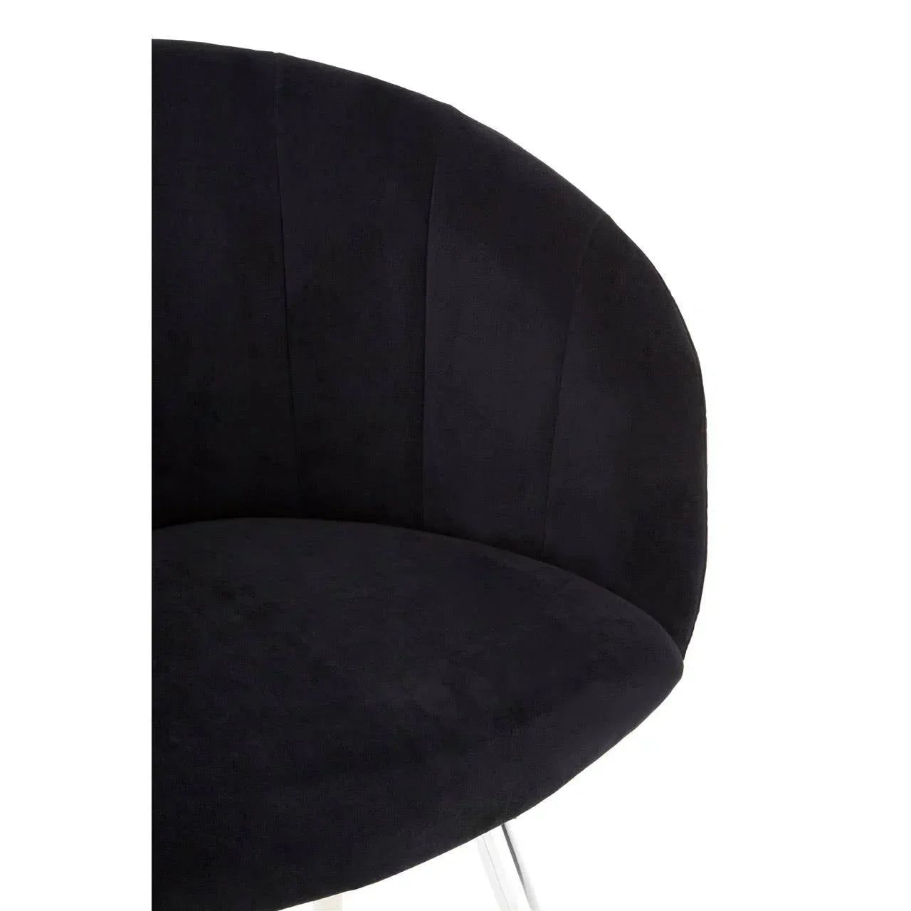 Black velvet accent chair with curved backrest and silver metal legs, close-up angle