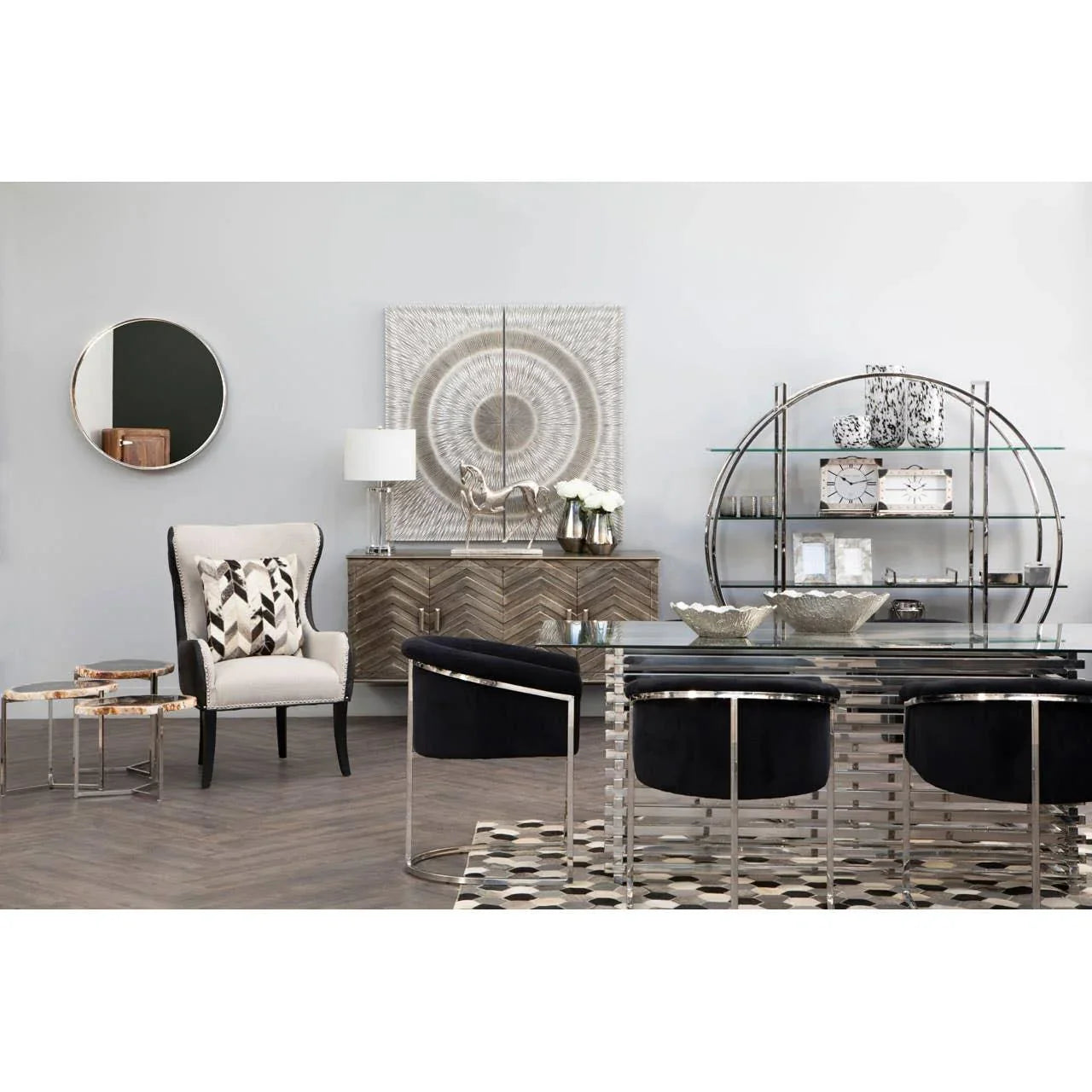 Modern dining room set with glass table, black velvet chairs, and metallic shelving unit