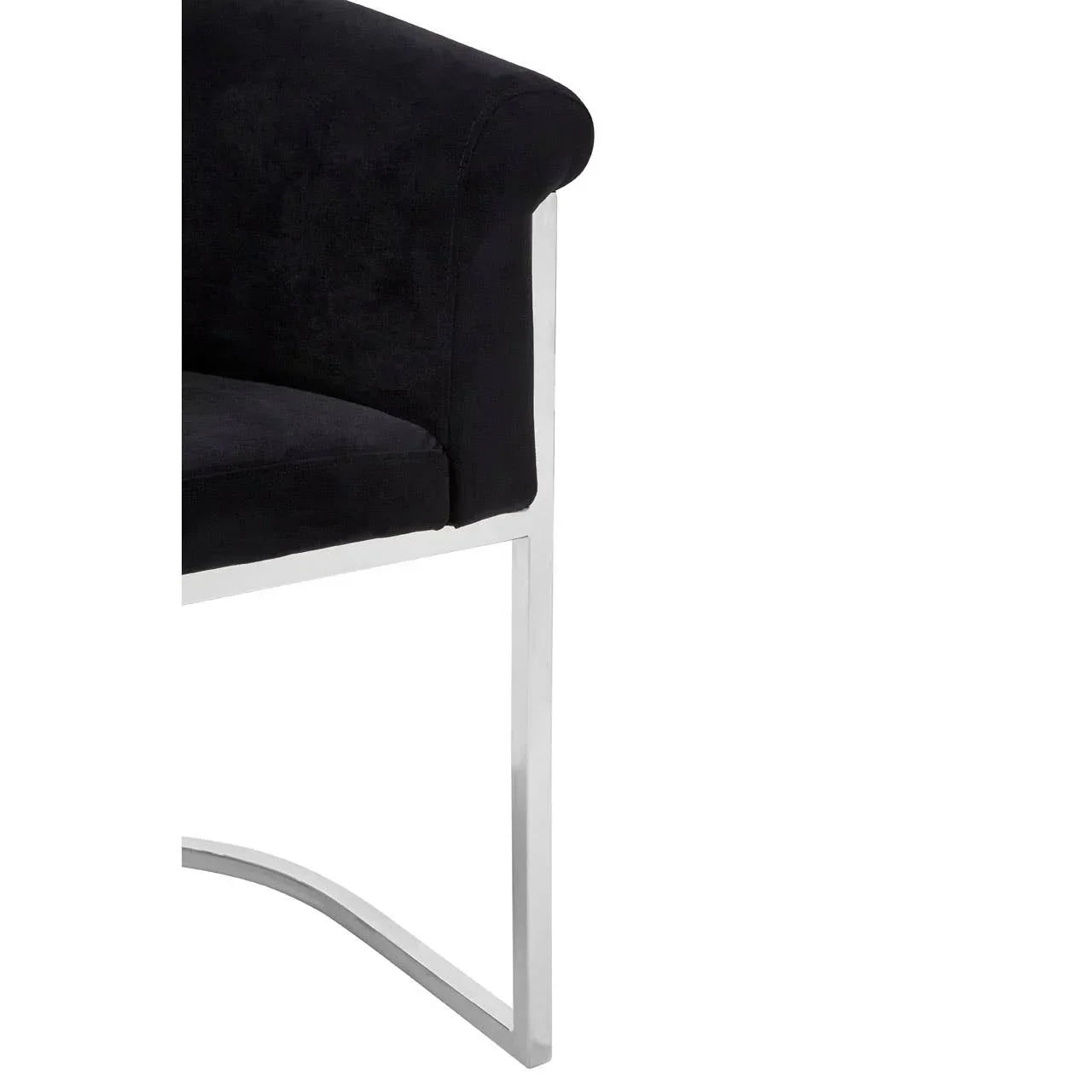 Black velvet chair with chrome metal frame and curved armrest, side angle view