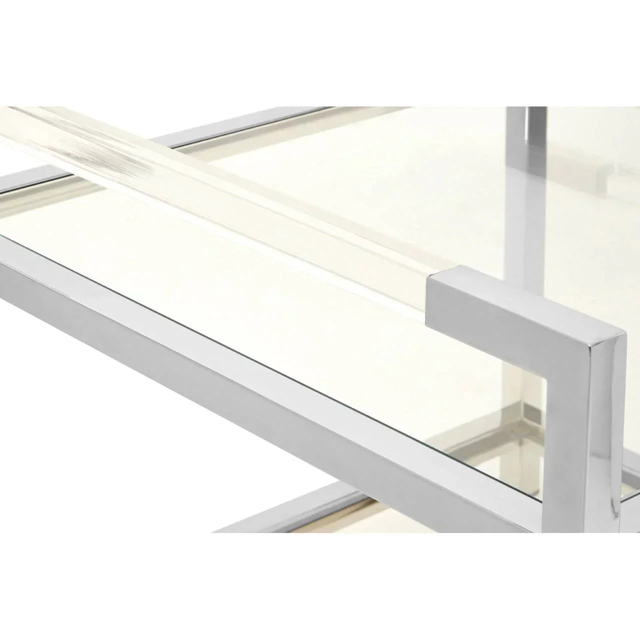 Close view of glass coffee table with chrome metal frame and clear surface