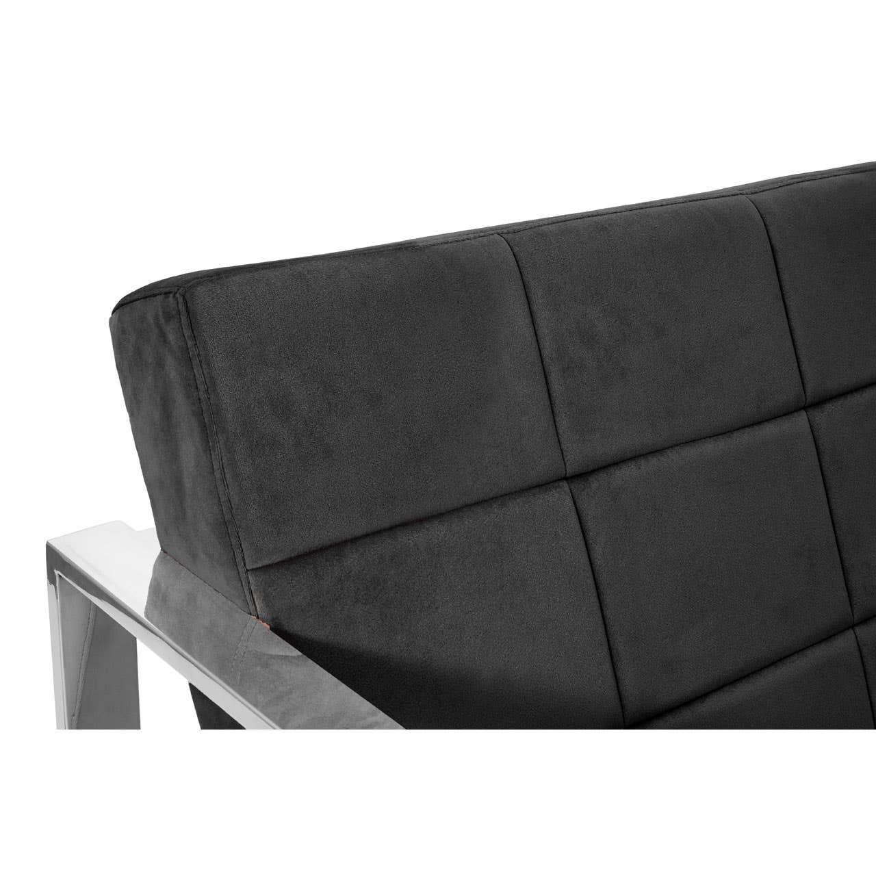 Closeup of modern sofa with black upholstered backrest and metal armrest