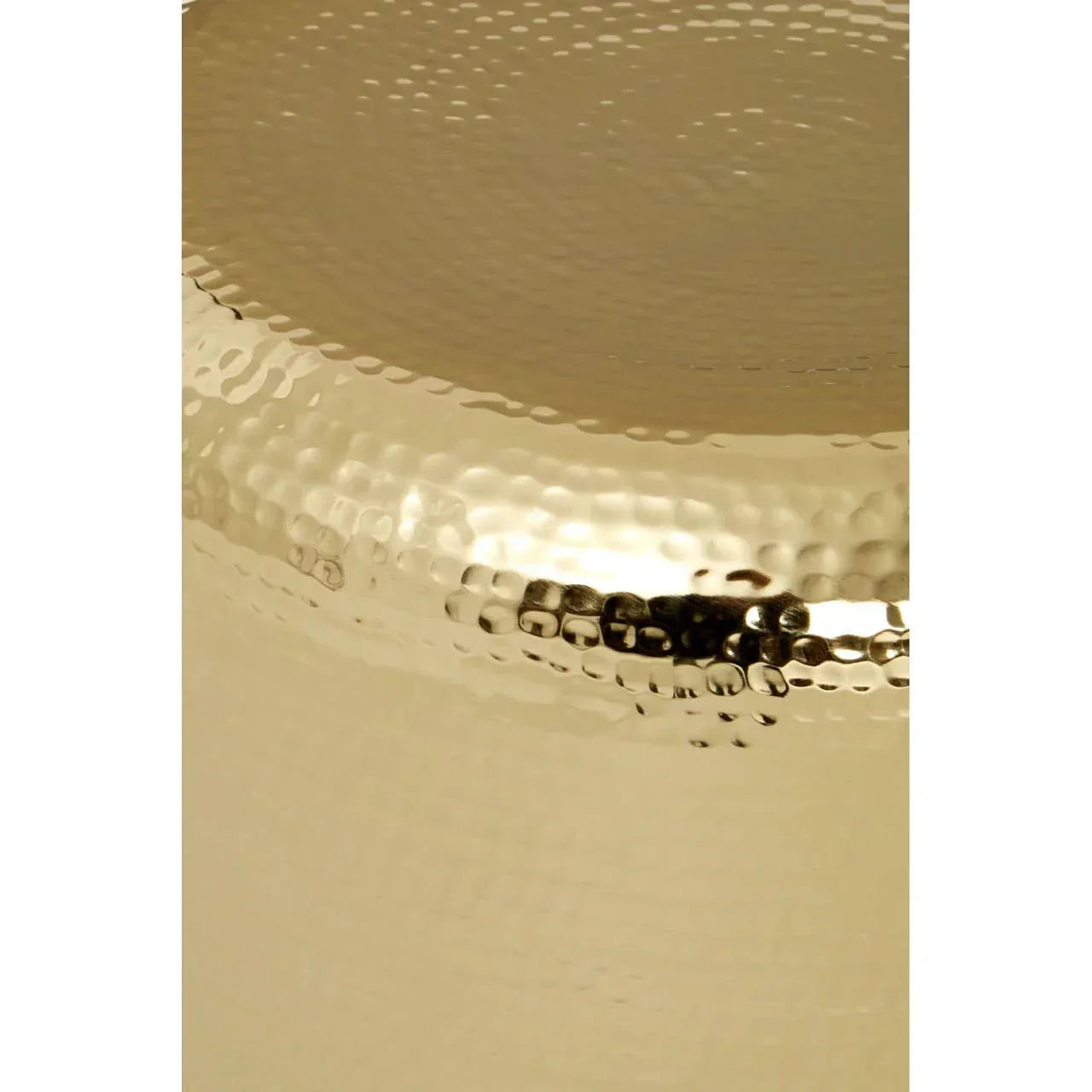 Close up of gold hammered metal side table surface with textured finish