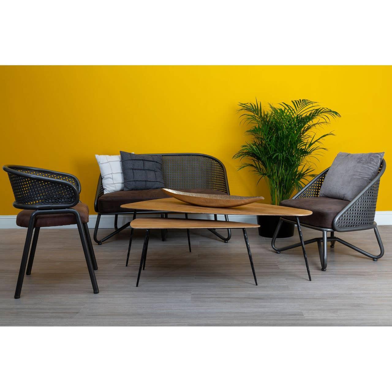 Contemporary rattan sofa set with grey cushions and wooden coffee tables against yellow wall