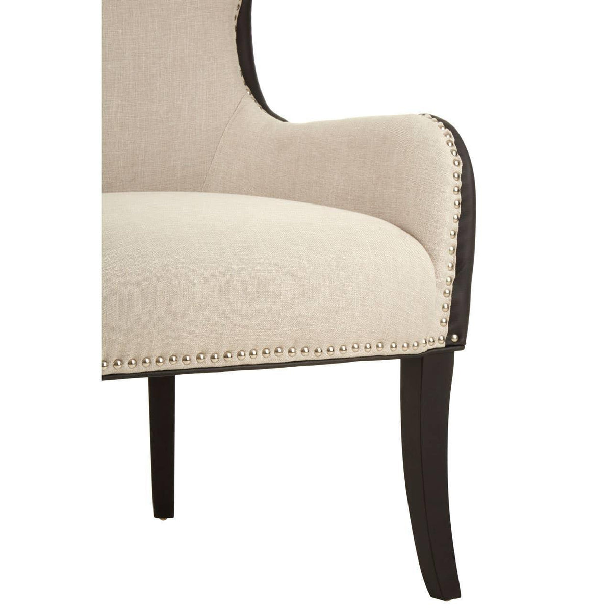 Beige upholstered armchair with studded detailing and dark wooden legs, side view
