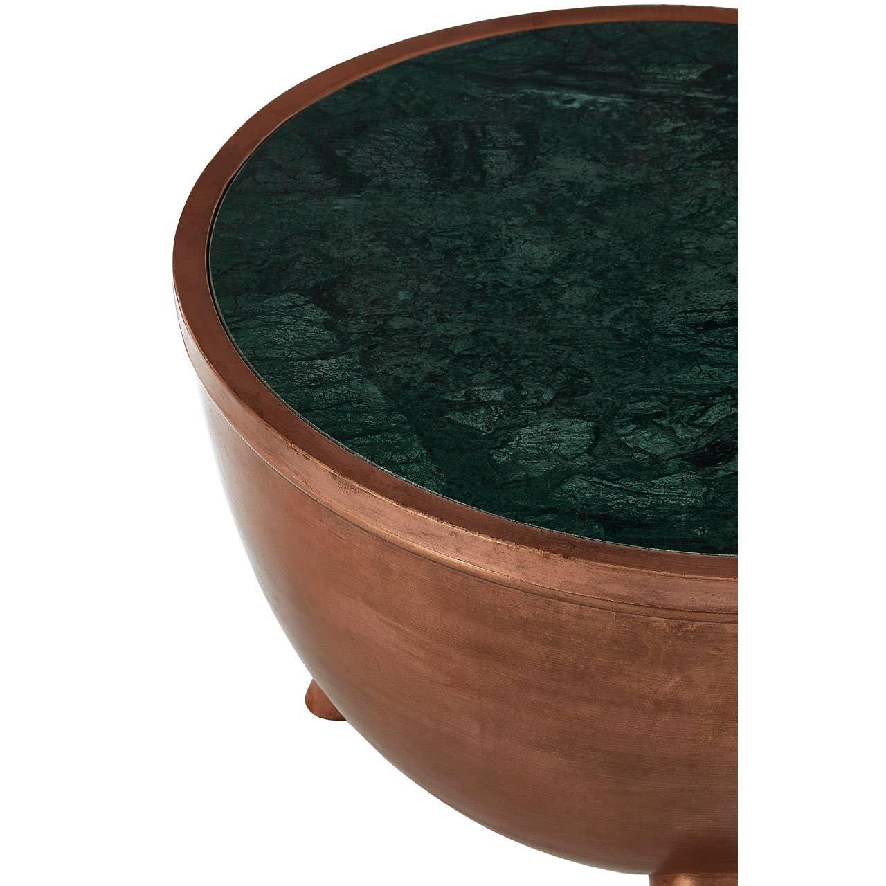 Round coffee table with dark green marble top and copper metal base, close-up angle