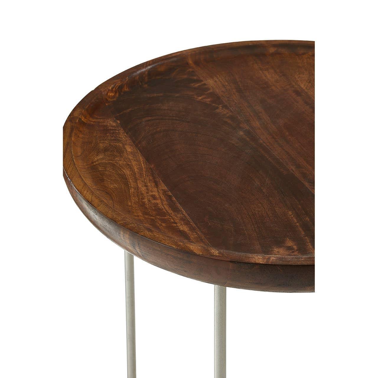 Round wooden side table top with visible grain and slim metal legs close-up