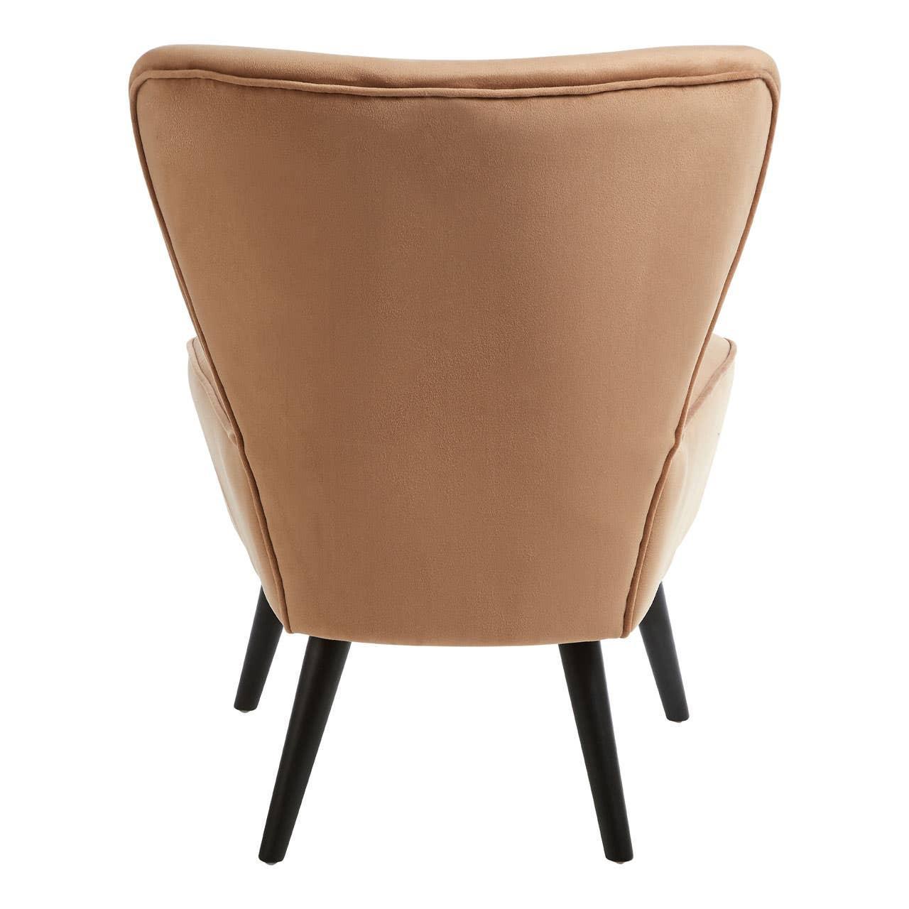 Tan fabric accent chair with black wooden legs, rear view highlighting chair back shape