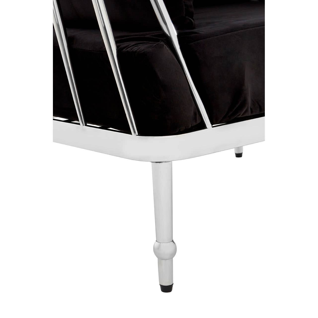 Black velvet upholstery with a sleek silver frame, showcasing a modern design. The sofa features a low back and clean lines, supported by slender legs. The overall aesthetic is elegant and contemporary, suitable for various interior styles