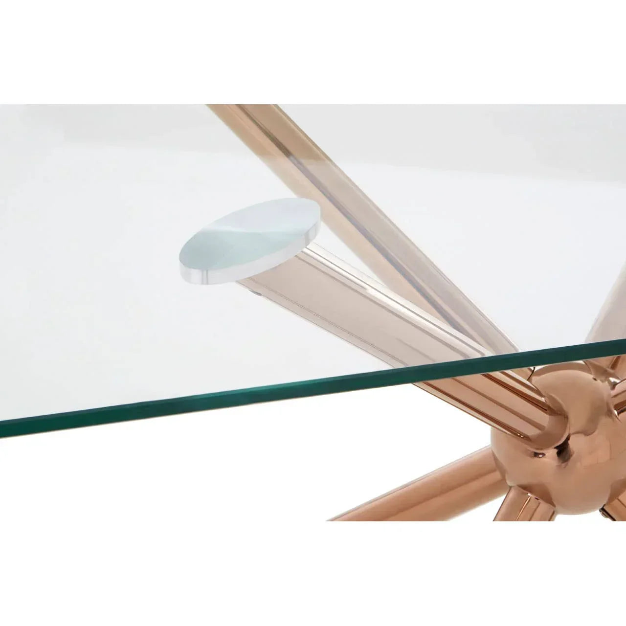 Glass dining table with gold metal legs and clear top closeup