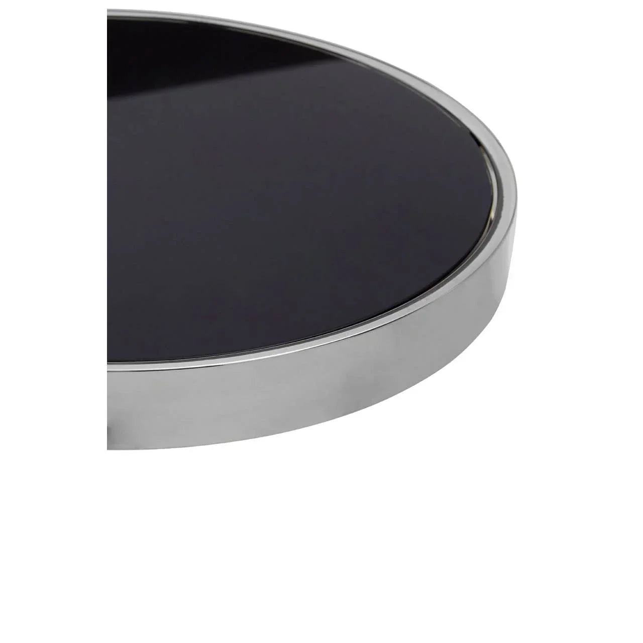 Round black glass table top with chrome metal edge, close-up view