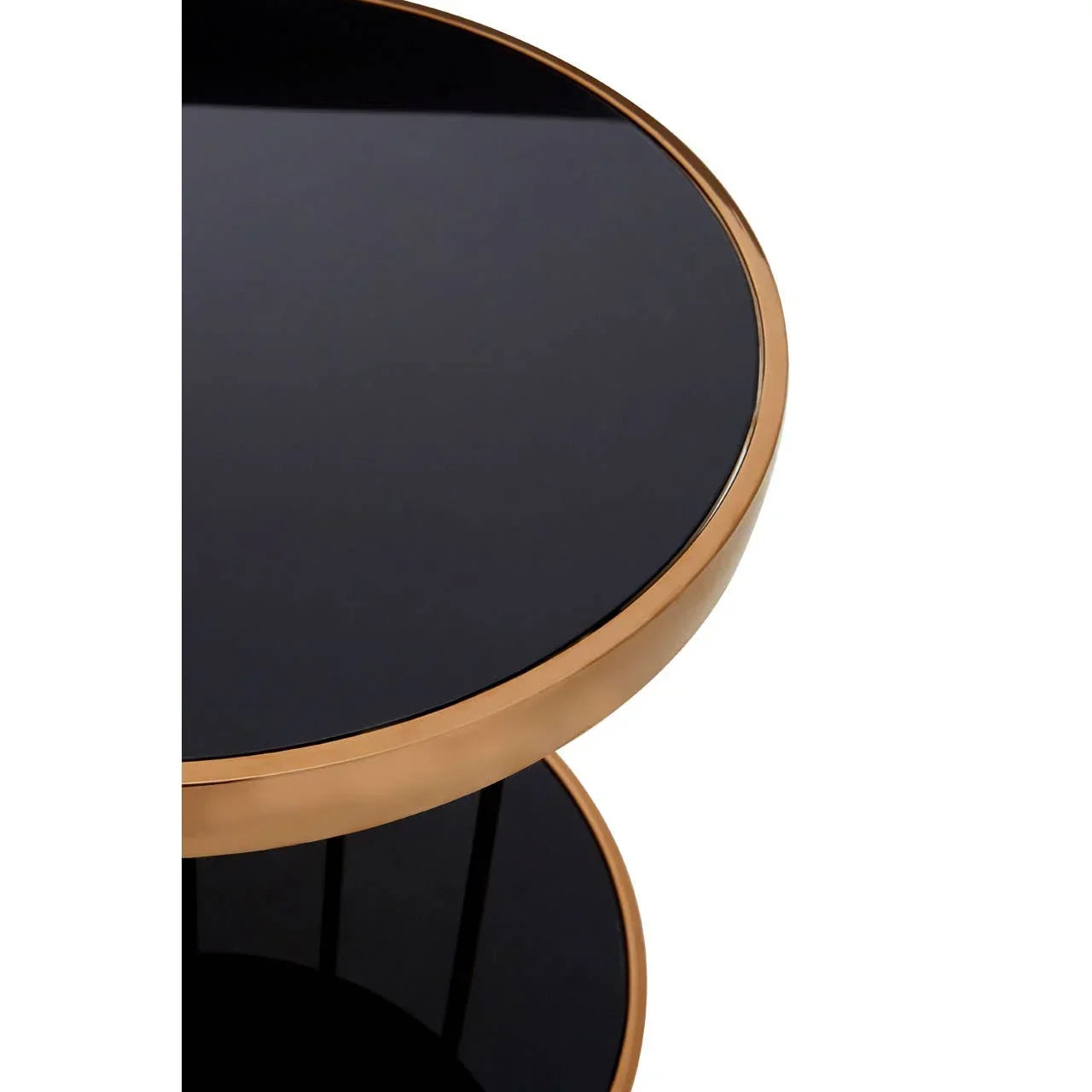 Round side table with black glass top and gold metal frame, modern closeup view