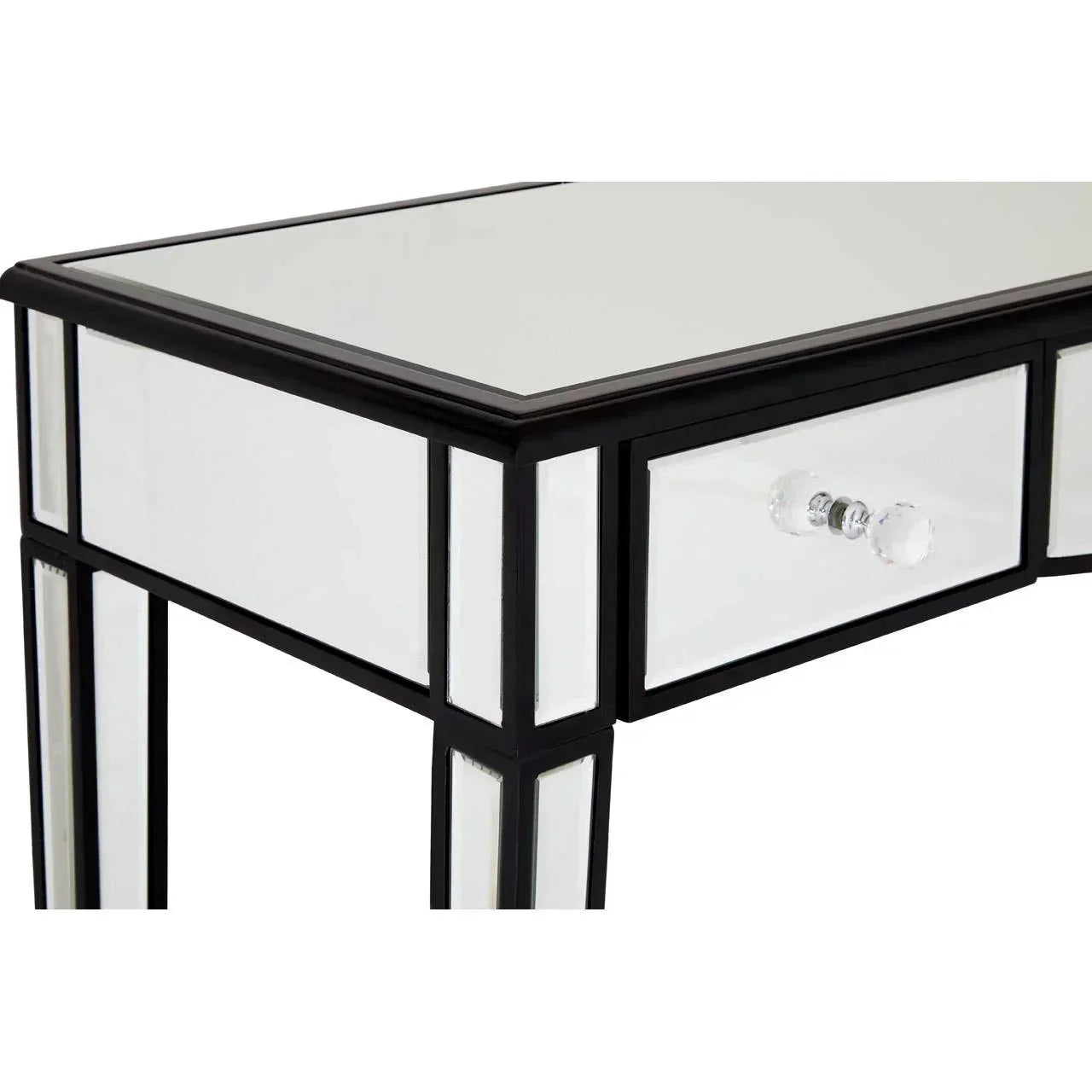 Mirrored dressing table with glass drawer knob and black trim, close view of corner detail