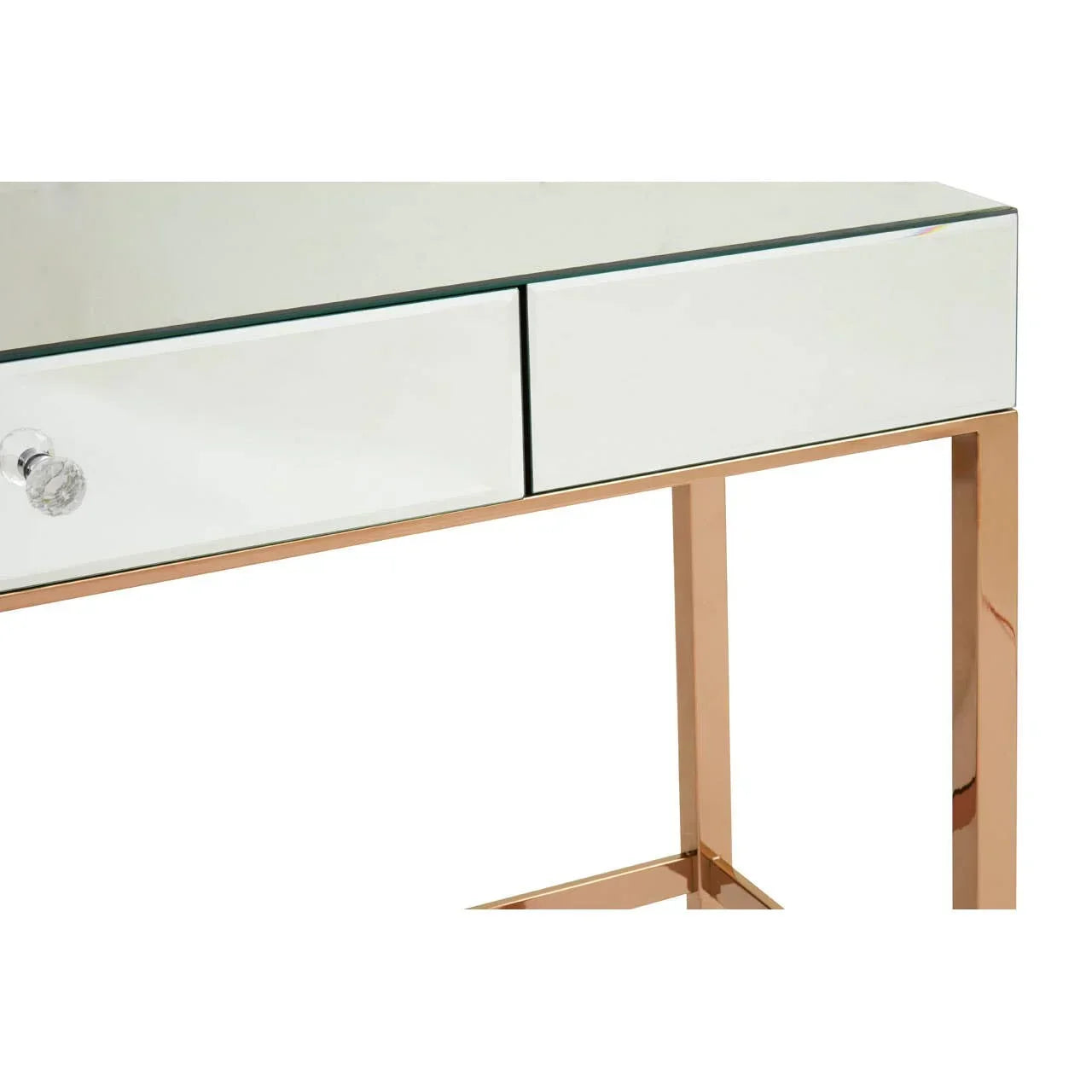 Mirrored console table with white drawer fronts and gold metal legs, close-up view