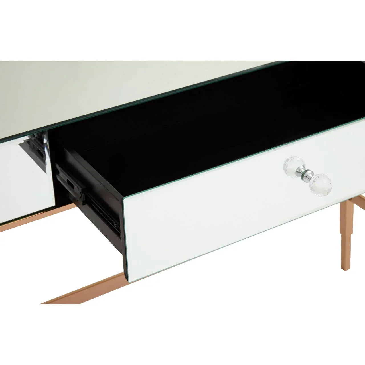 Mirrored dressing table drawer with glass handle and gold metal legs, close-up view