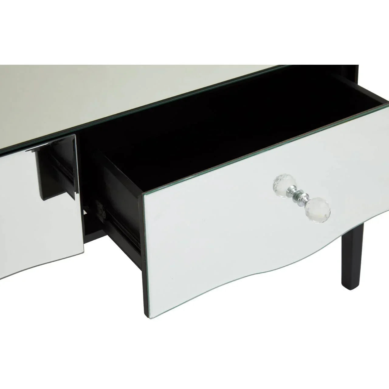 Mirrored drawer with glass knob and black interior, close-up of furniture storage