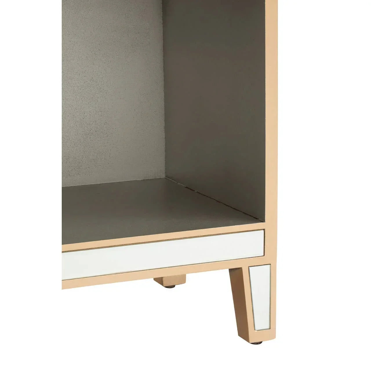 Mirrored bedside table corner with gold frame and open shelf detail