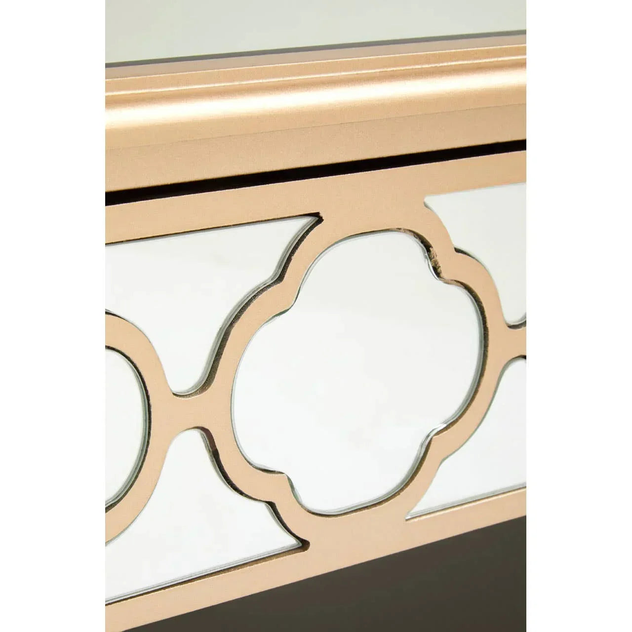 Mirrored console table with gold geometric frame detailing, close-up of tabletop edge