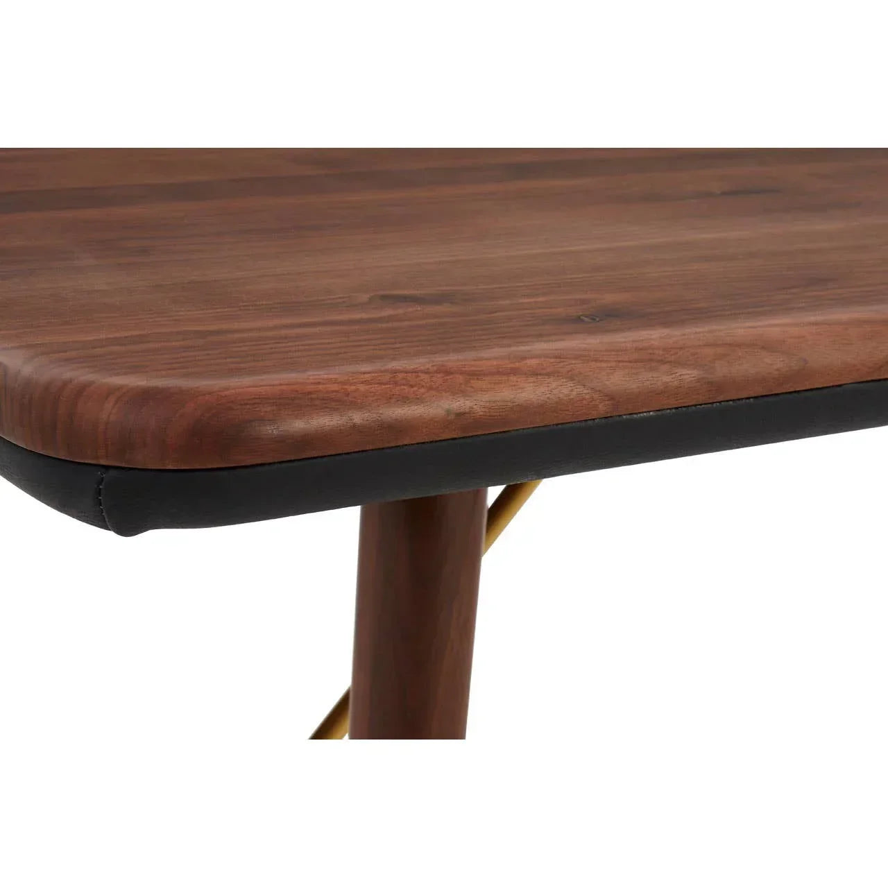 Close-up of wooden dining table corner with dark edge and slim wooden leg