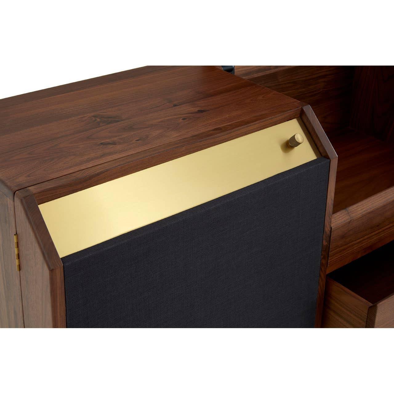 Walnut wood storage unit with black fabric front and gold accent panel