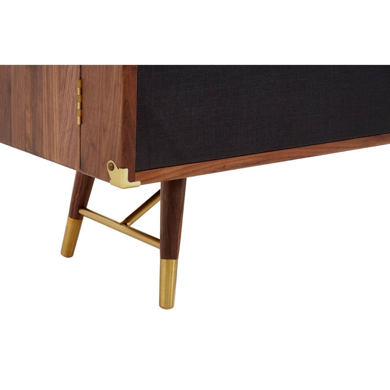 Walnut sideboard leg detail with black panel and gold metal accents