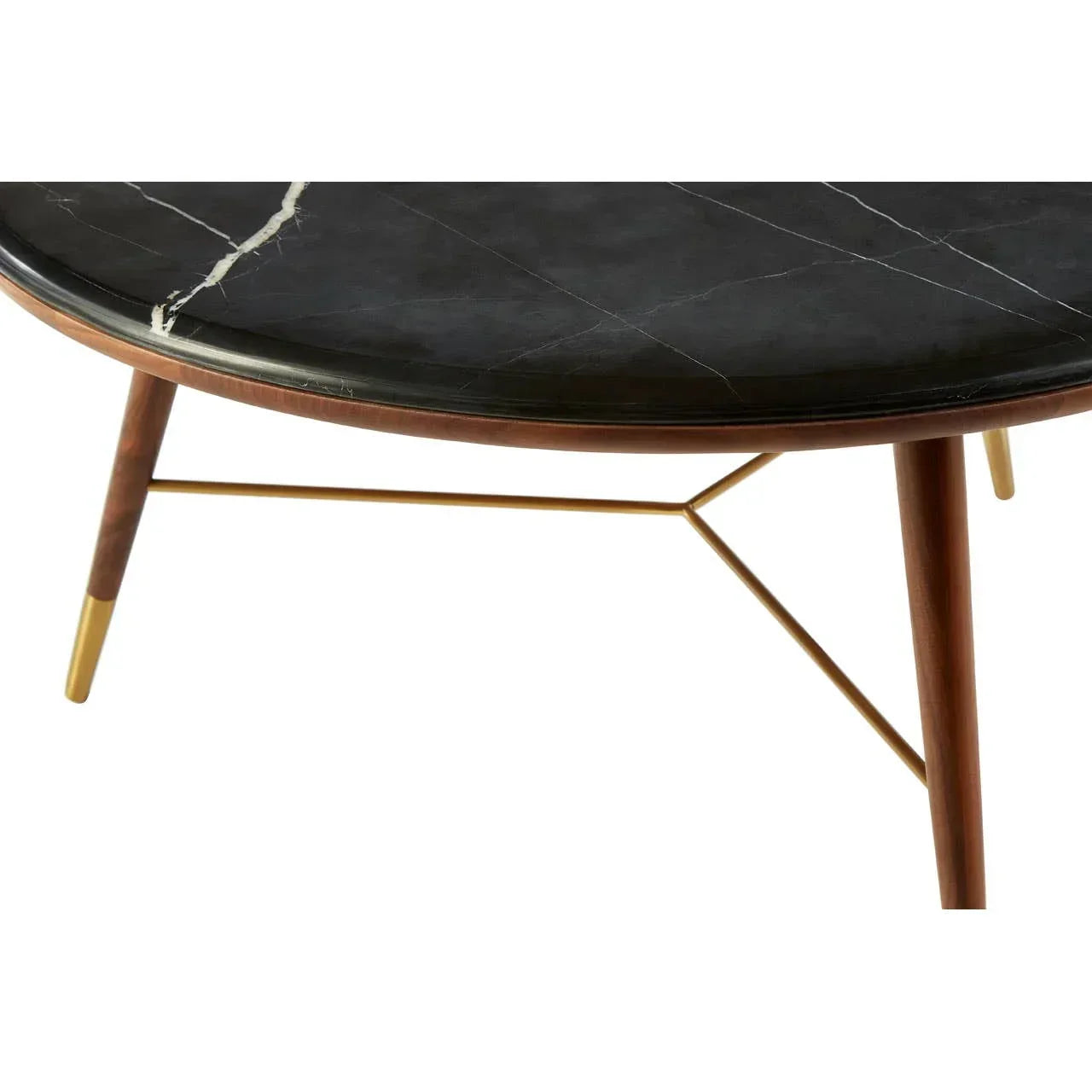 Round black marble coffee table with gold legs and wood accents, close view of top