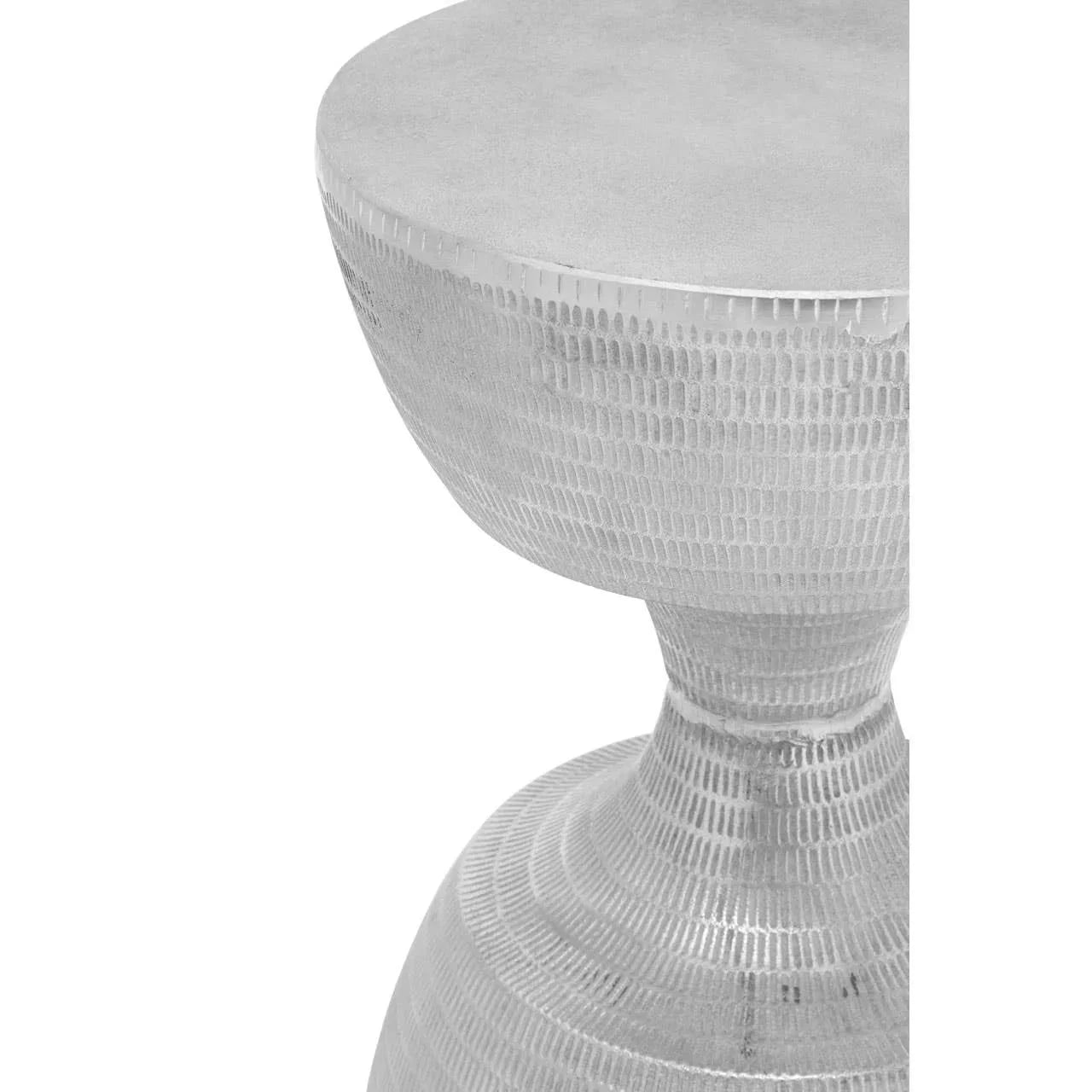Silver metallic textured side table with round top, close-up on modern finish