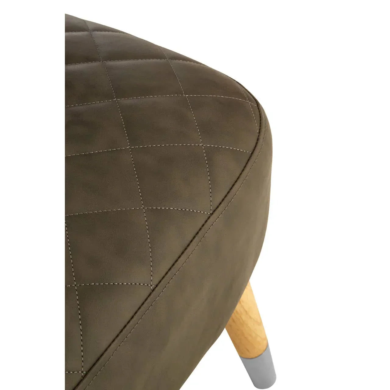 Close-up of quilted brown ottoman upholstery with wooden leg