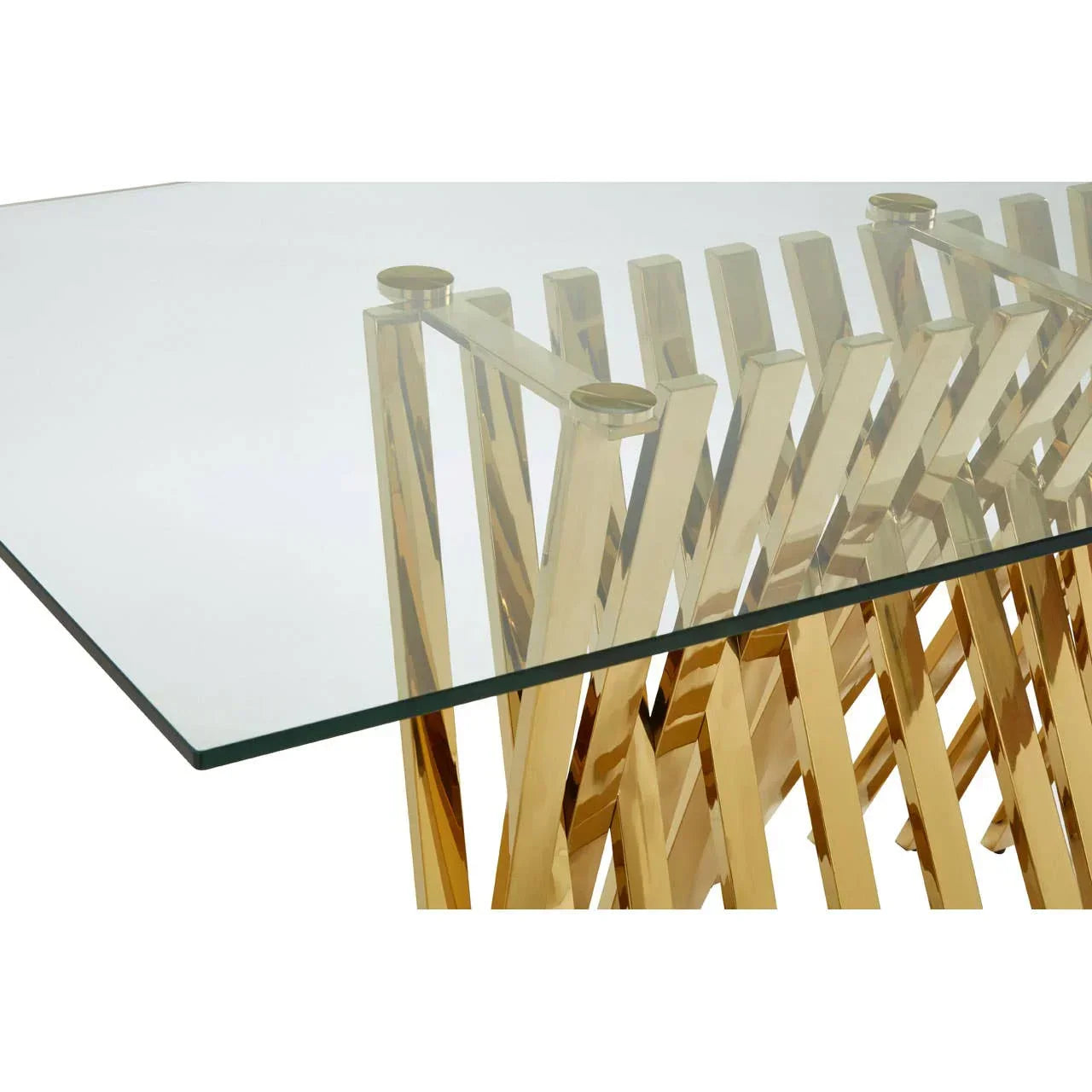 Glass dining table with gold metal geometric base, angled view showing tabletop detail