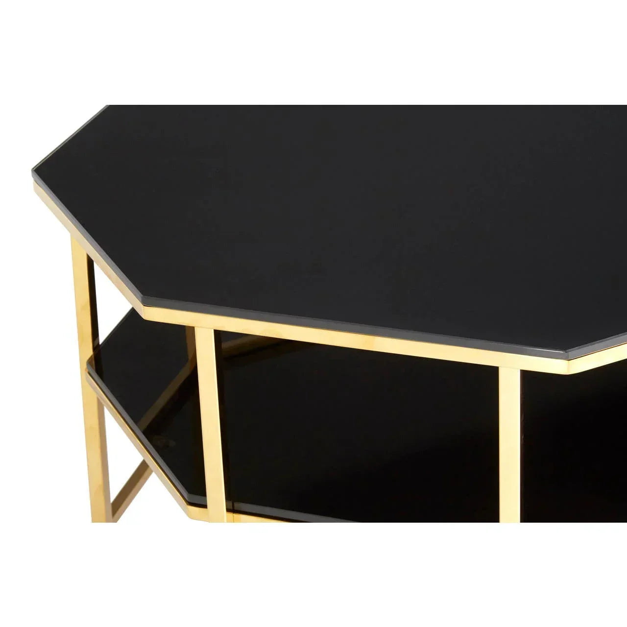 Black glass coffee table with gold metal frame and geometric design, close-up view