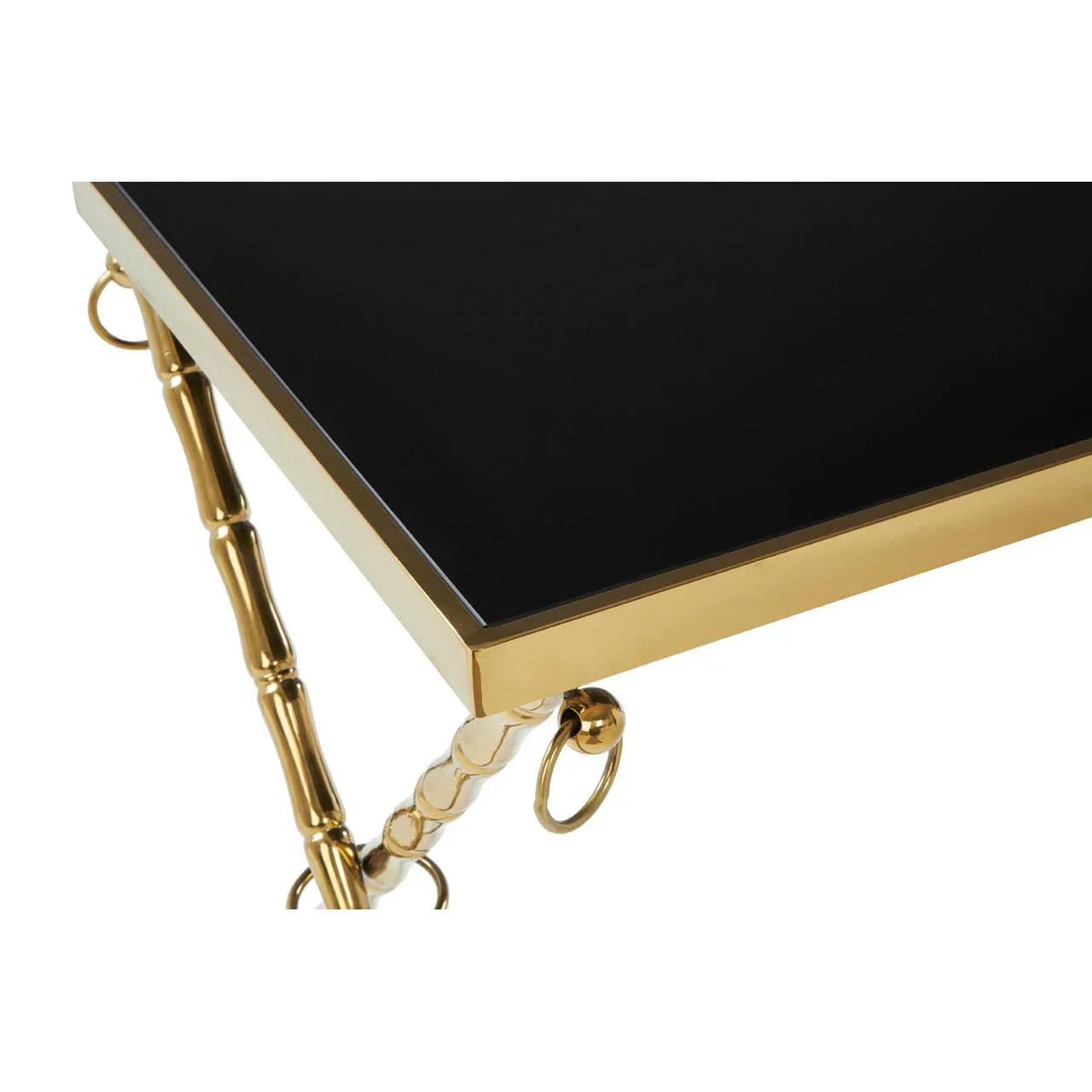 black glass coffee table with gold metal frame and bamboo style legs, corner detail view