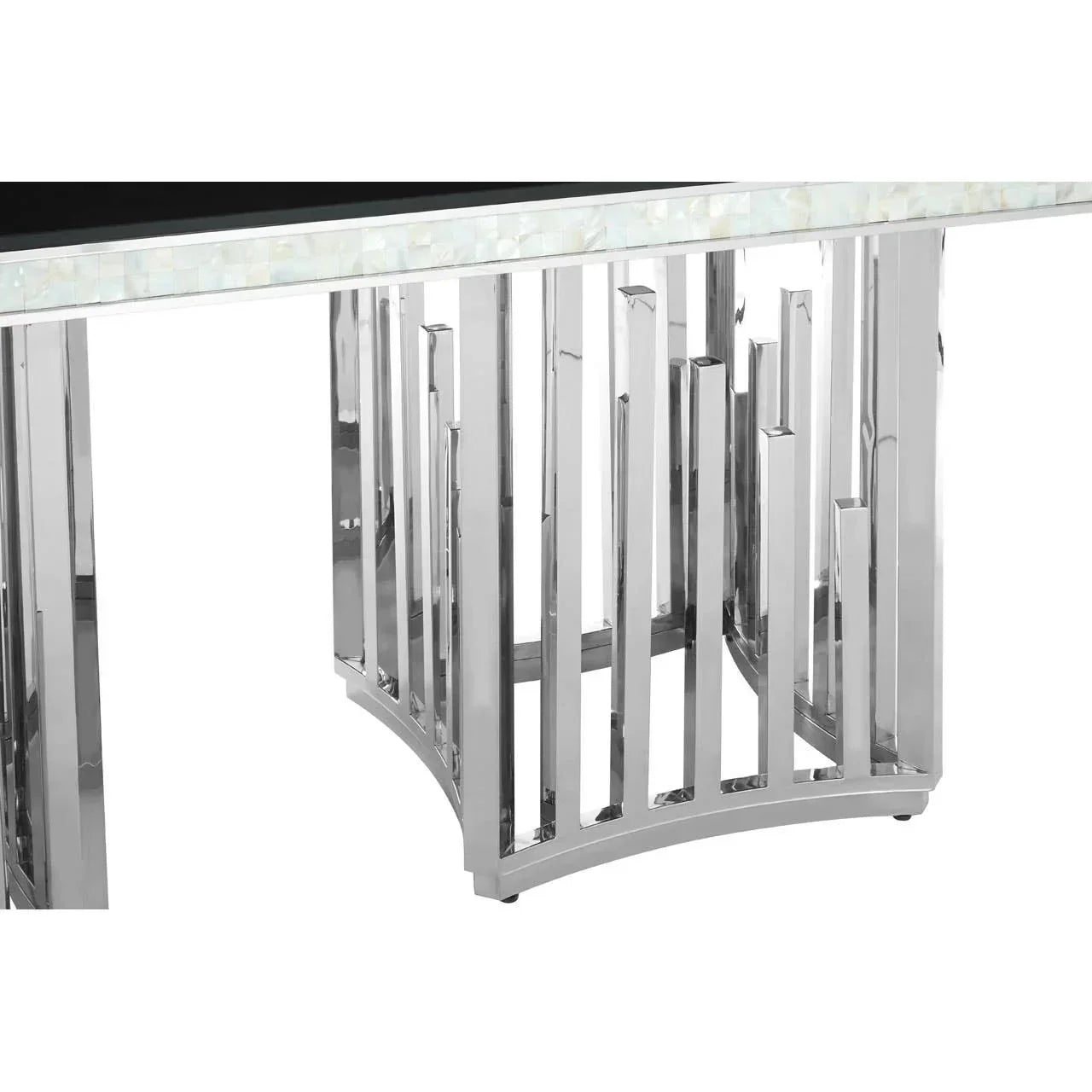 Close-up of chrome dining table base with geometric metal legs and stone inlay edge