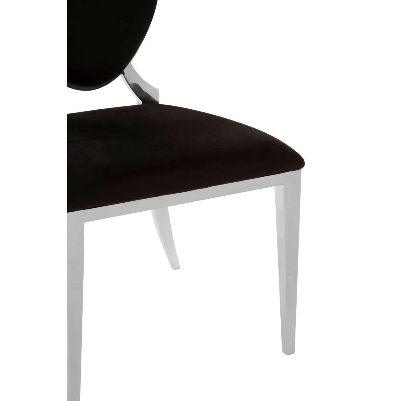 Black velvet dining chair seat with chrome legs, close-up view