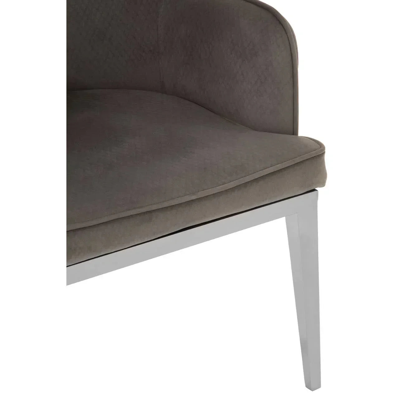 Grey velvet dining chair with chrome leg and curved backrest, close-up angle
