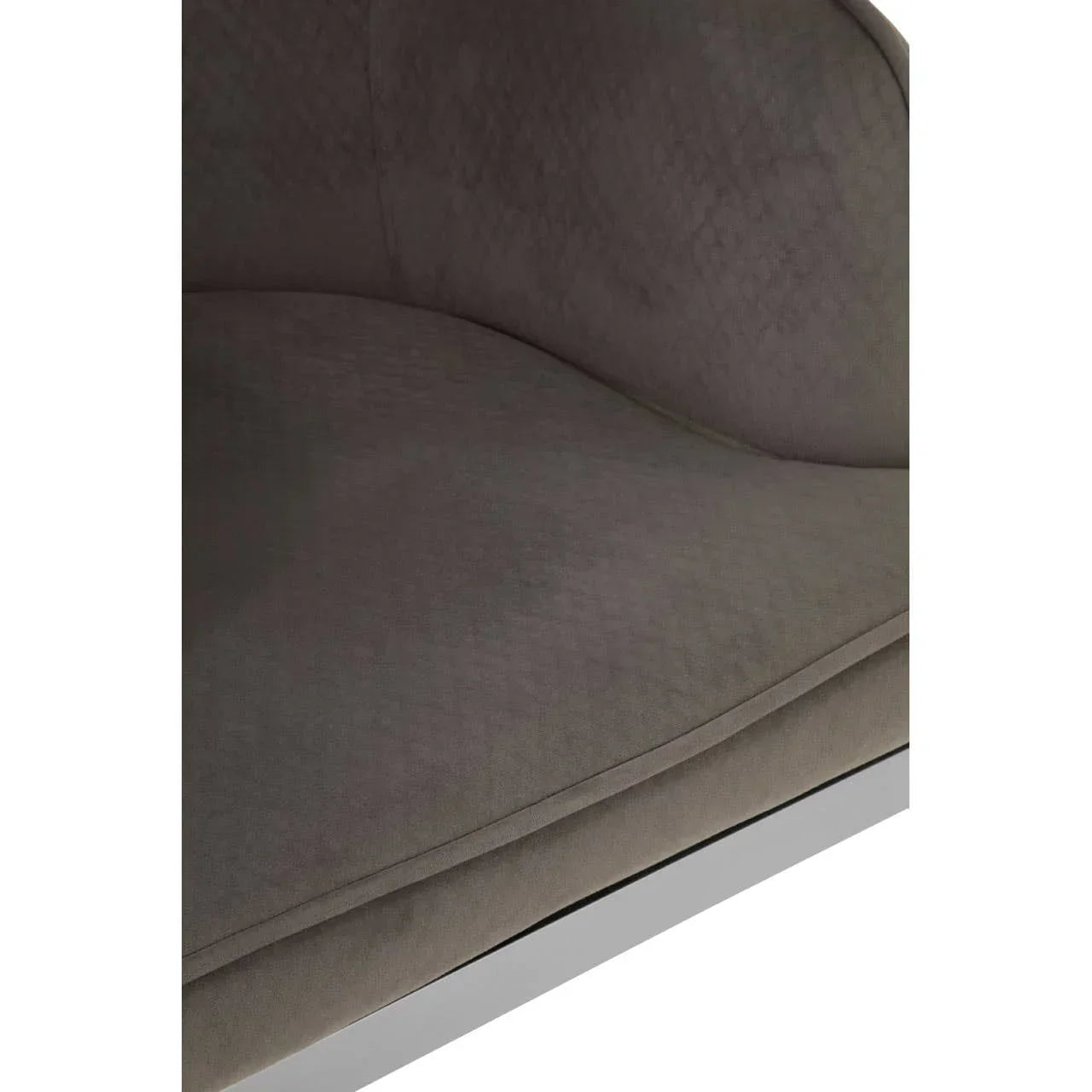 Close-up of grey fabric armchair seat with stitched pattern and curved backrest
