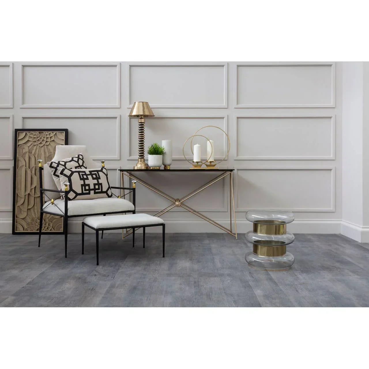Modern accent chair with ottoman, gold console table and glass stool in stylish living room