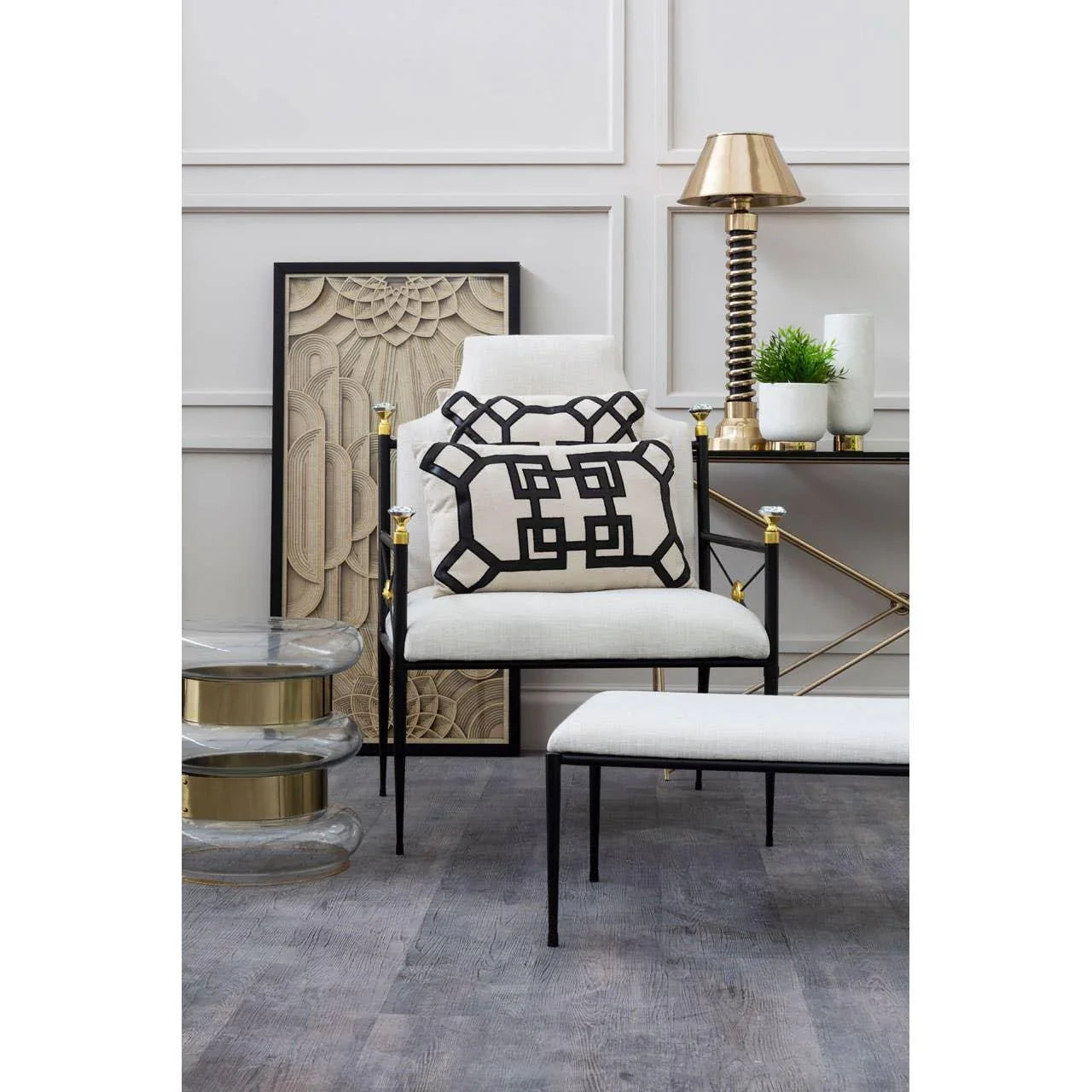 Modern accent chair with geometric cushion and white ottoman in minimalist living room
