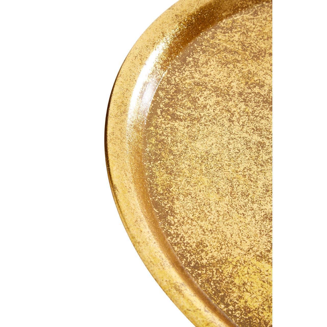 Close-up of round gold tray with textured metallic finish