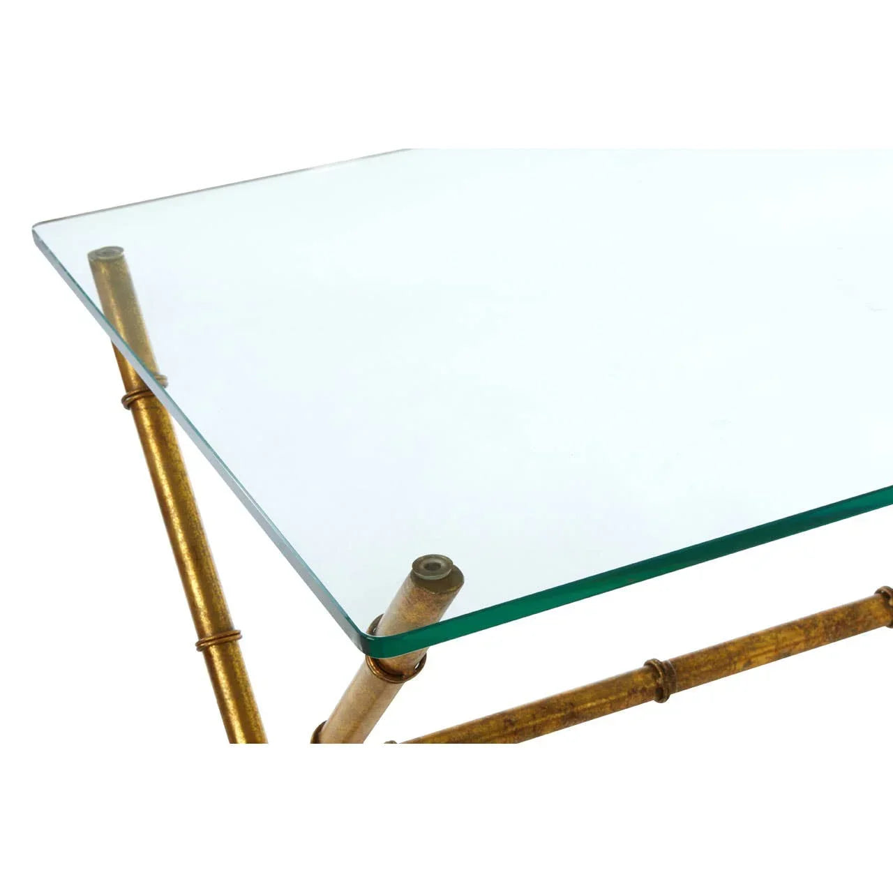 Glass coffee table with gold bamboo-style metal legs, corner detail view
