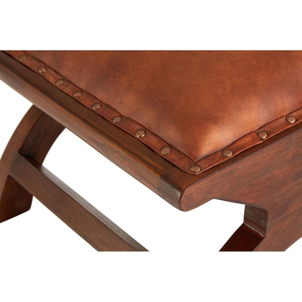 Brown leather bench seat with stud detailing and solid wooden frame close-up